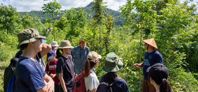 Participants learning about the ridge-to-reef approach in the Bukit Indah Reforestation and Watershed Regeneration Project 