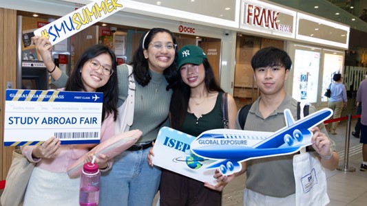 Happy international students holding various placards