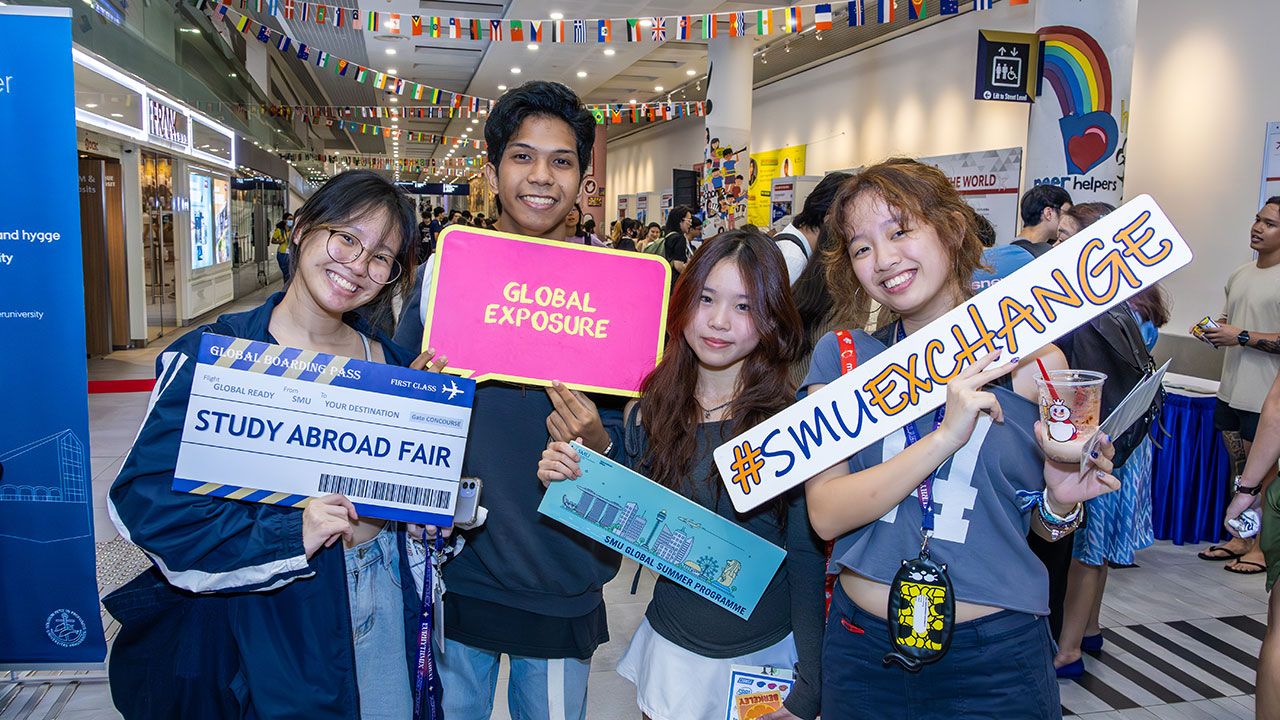 Student smiling in the photo taken during the Study Abroad Fair