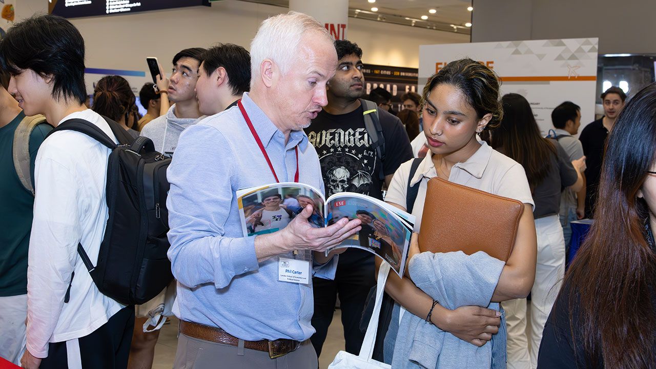 Faculty member talking to a student during Study Abroad Fair